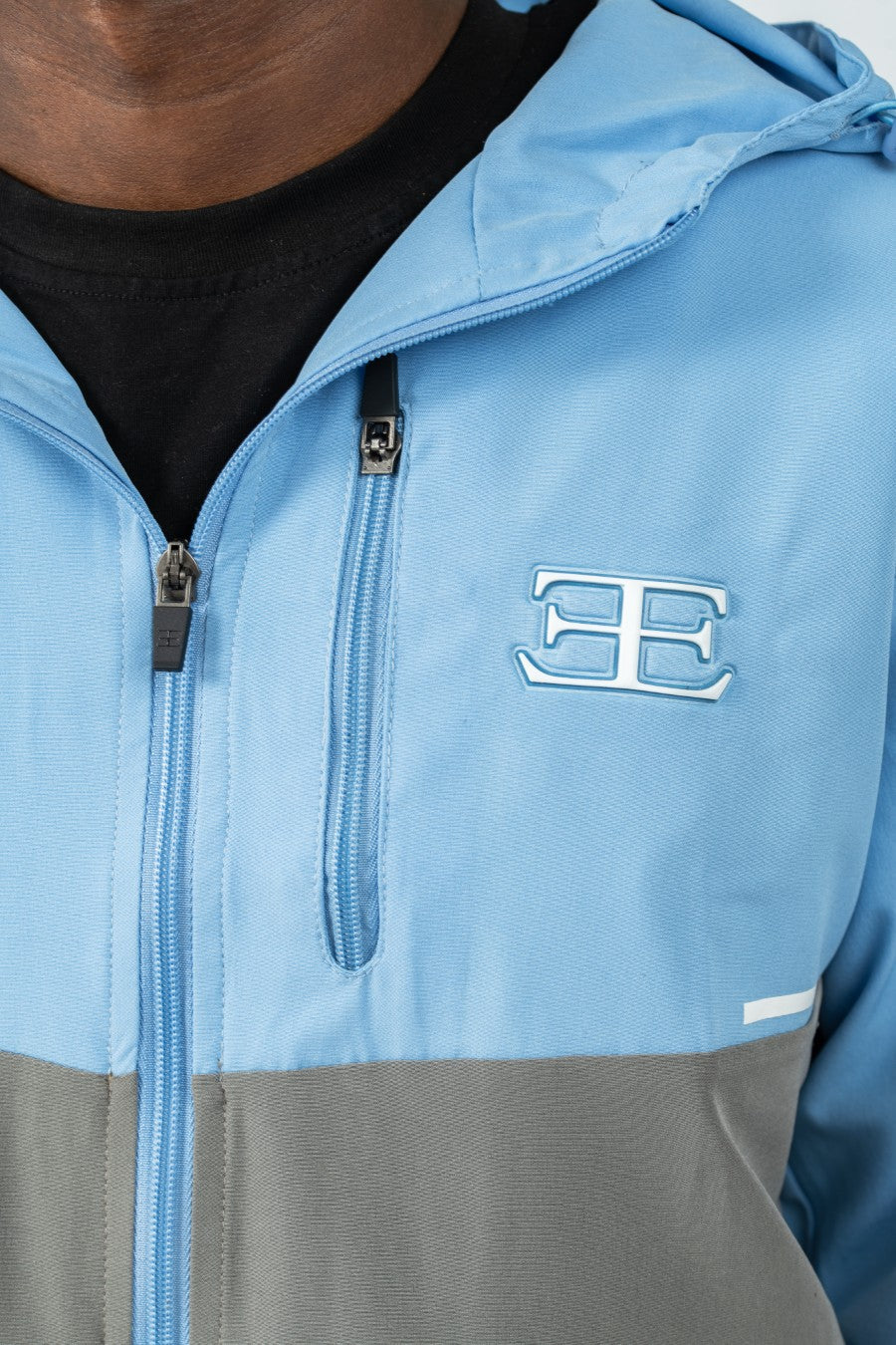 Blue and gray jacket with a logo on the chest