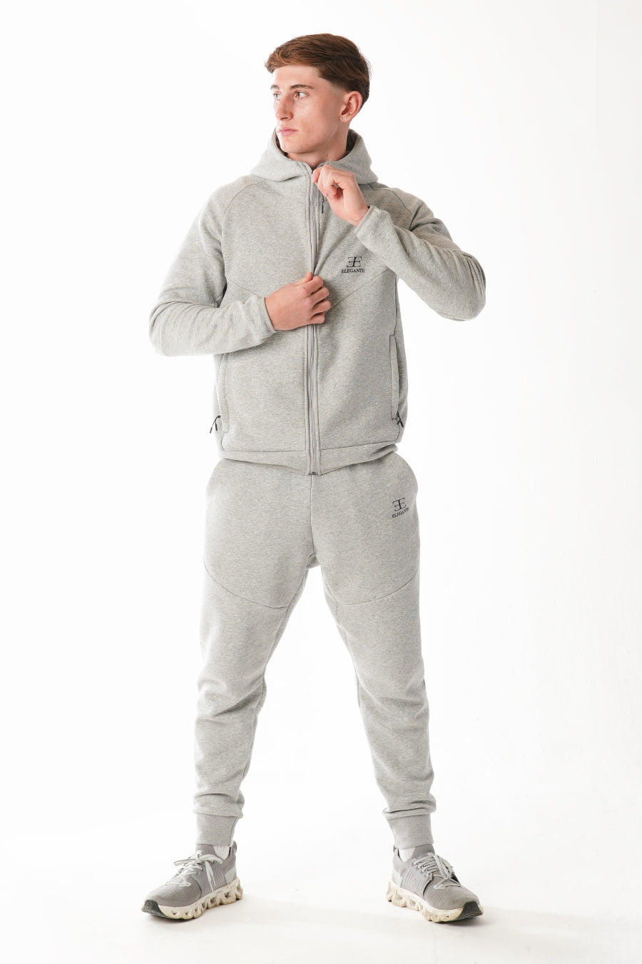 Man wearing Hazel Grey tracksuit on white background