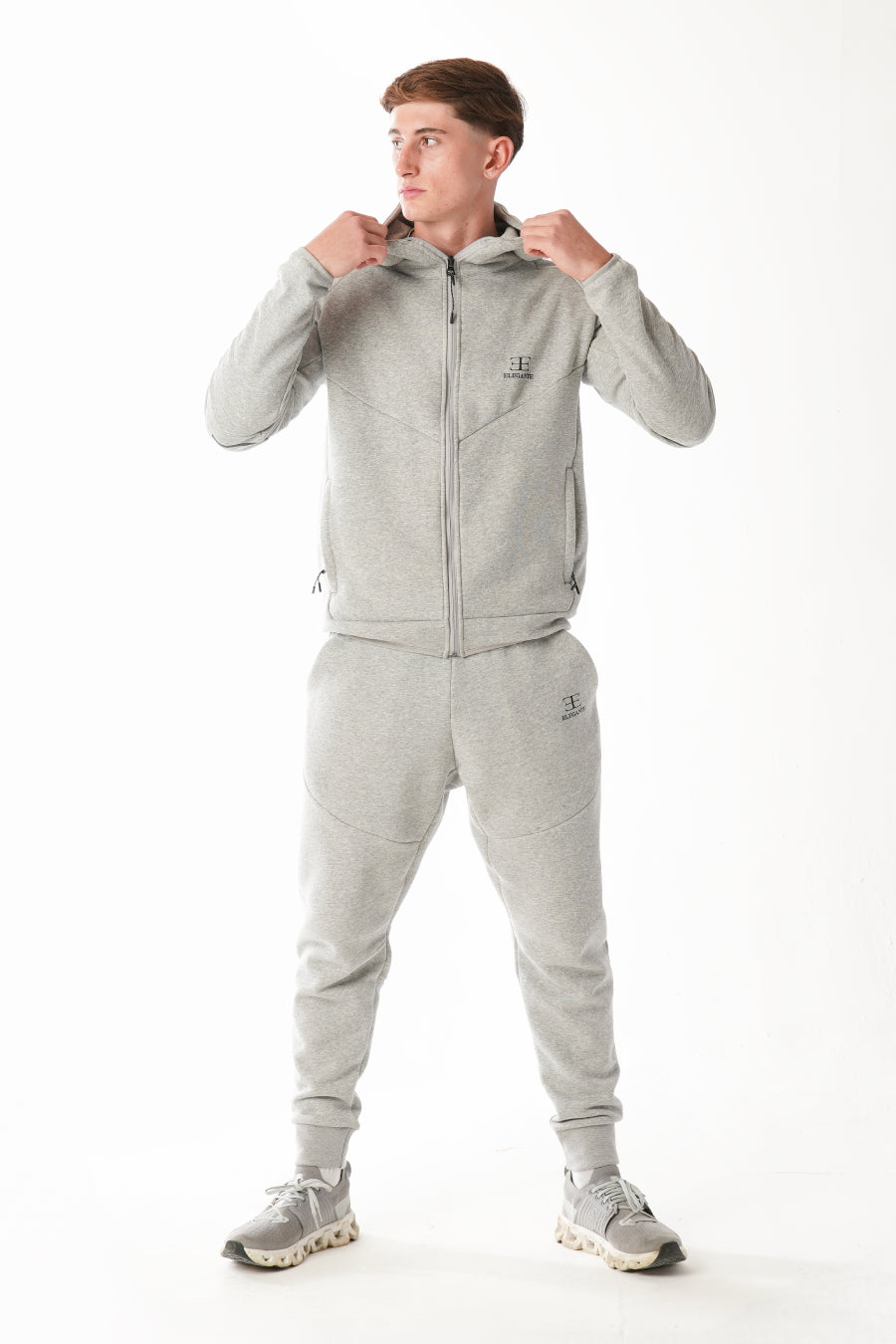 Man wearing Hazel Grey tracksuit on white background