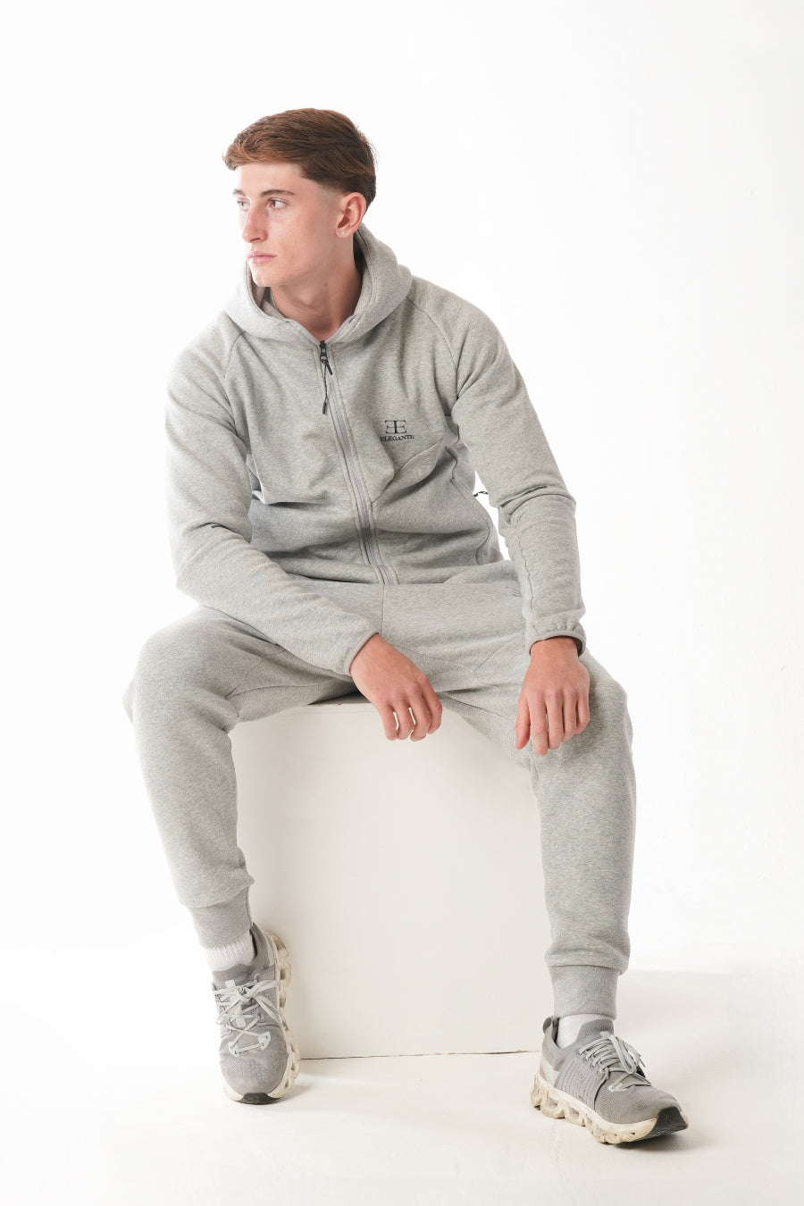 Man wearing Hazel Grey tracksuit on white background