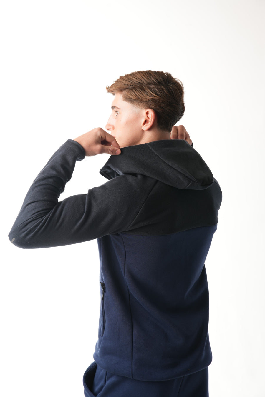 Man wearing midnight blue navy Tracksuit with hoodie on white background