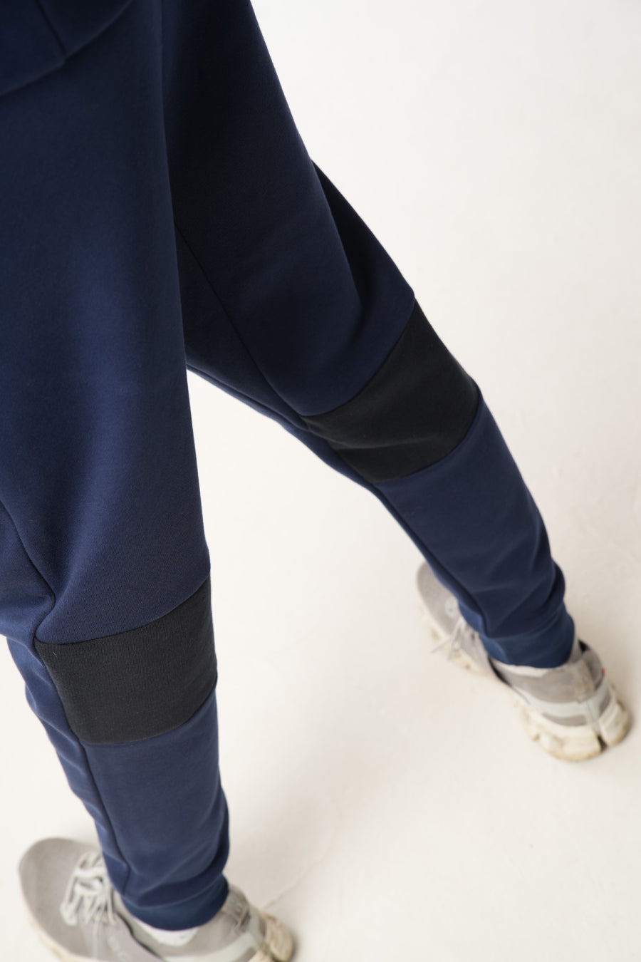 Man wearing midnight blue navy Tracksuit on white background
