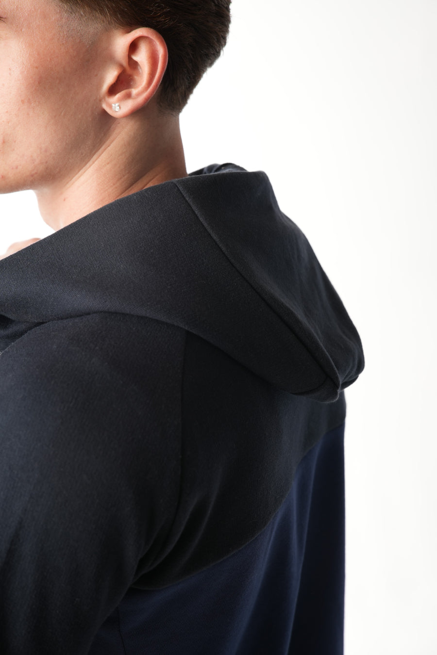 Man wearing midnight blue navy Tracksuit on white background