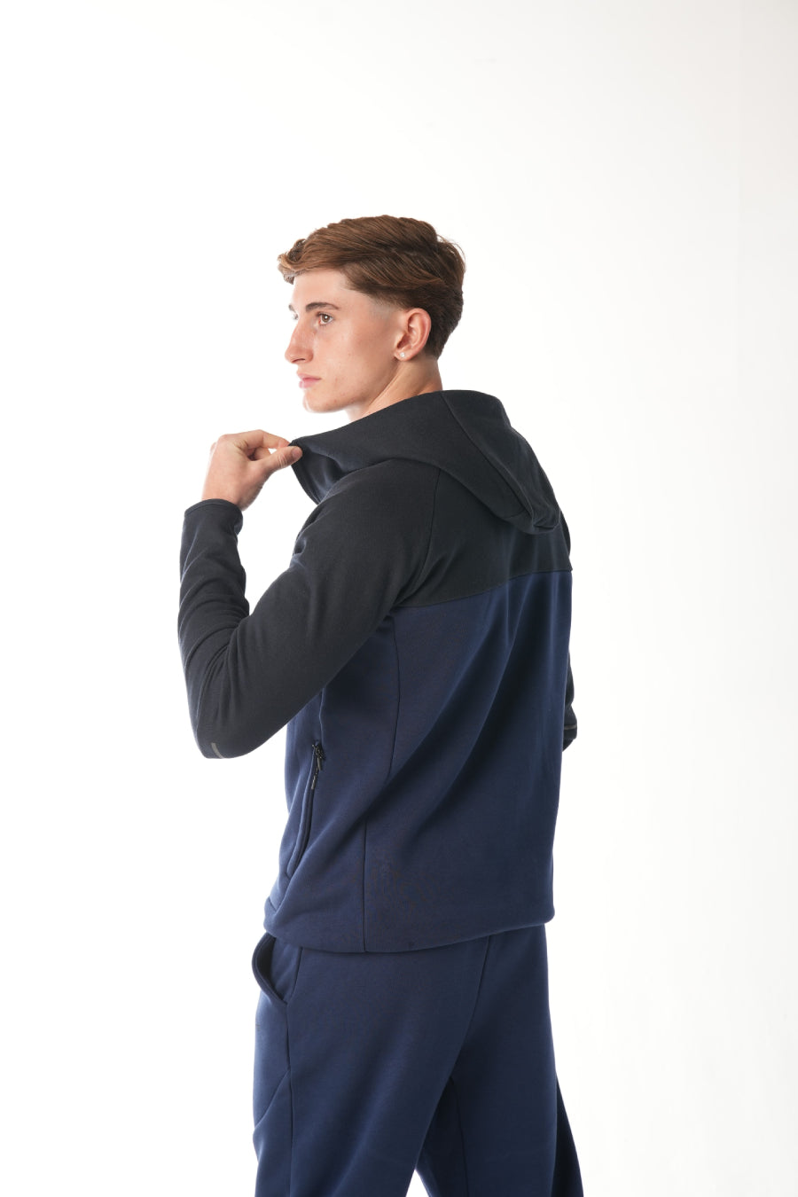 Man wearing midnight blue navy Tracksuit on white background
