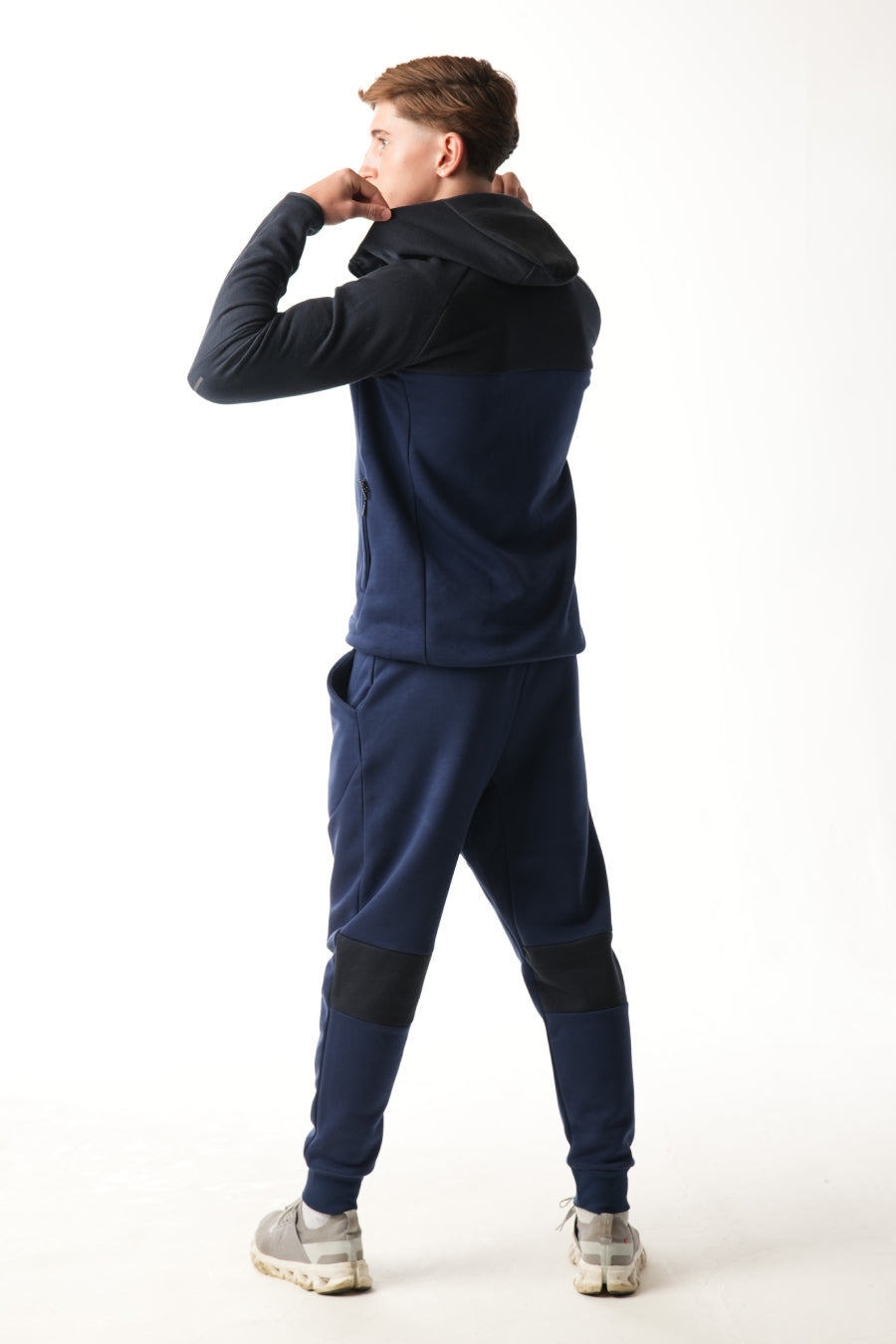 Man wearing midnight blue navy Tracksuit on white background