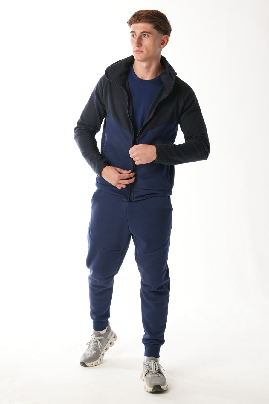 Man wearing midnight blue navy Tracksuit on white background