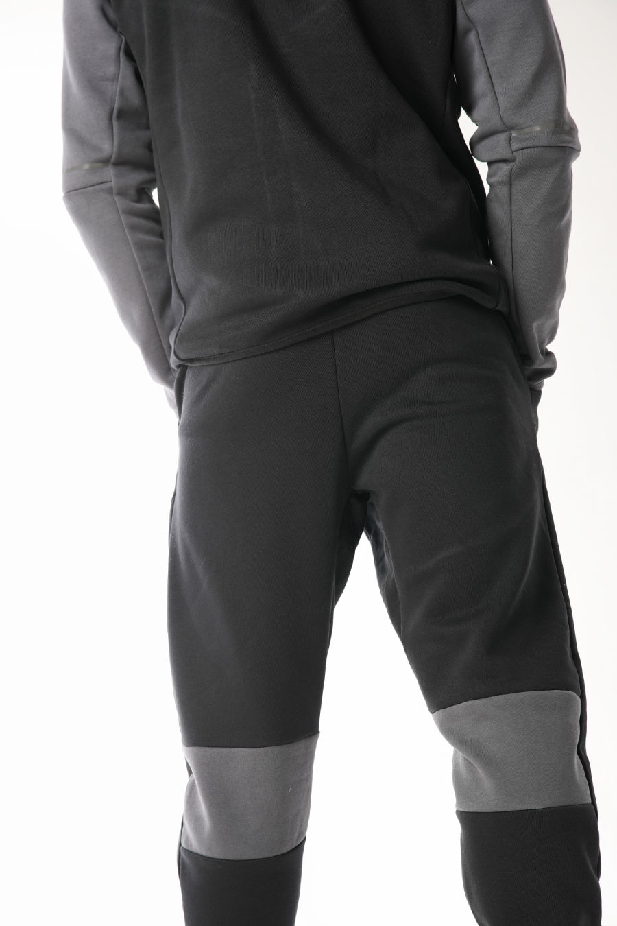 Man wearing Black steel grey Tracksuit on white background
