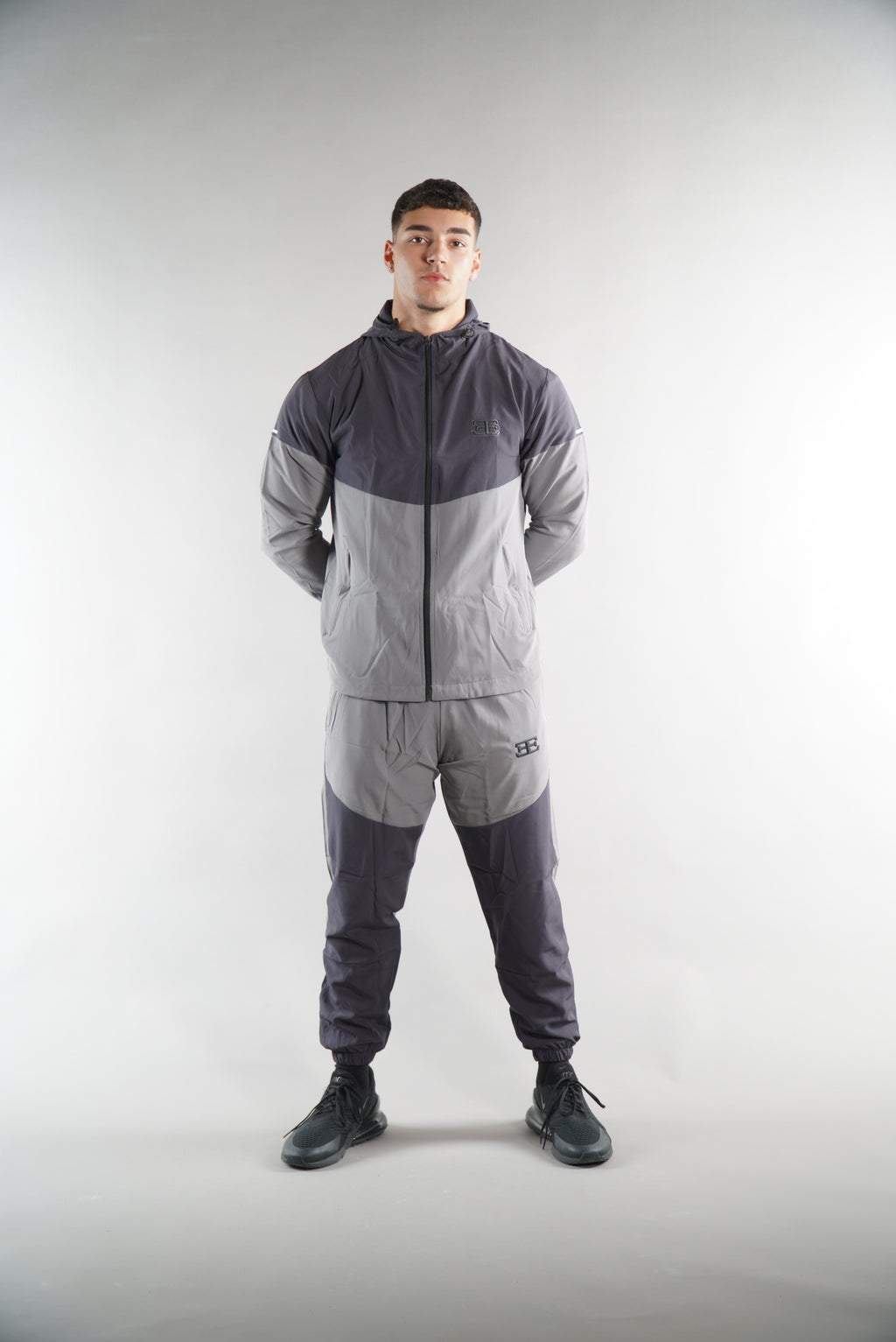 man wearing Grey Tracksuit joggers and tracksuit jacket with hood, activewear clothing
