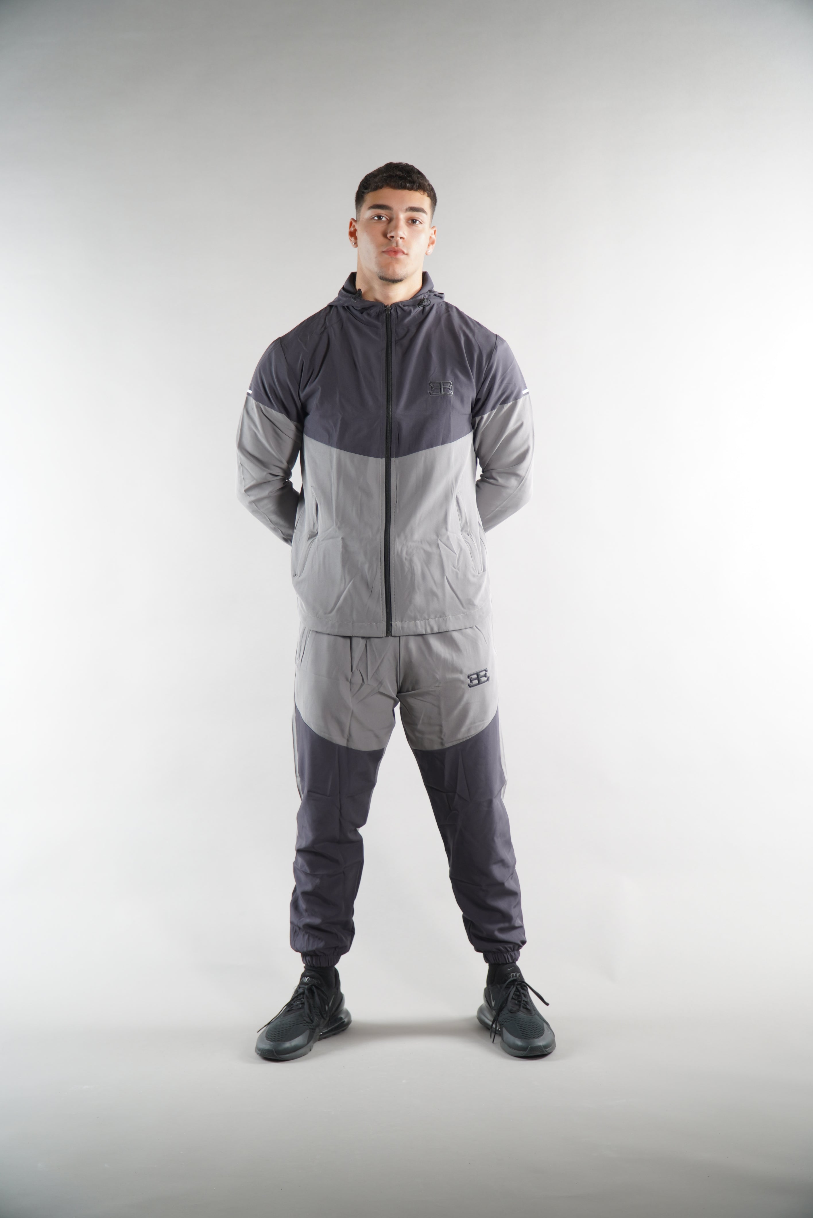 man wearing Grey Tracksuit joggers and tracksuit jacket with hood, activewear clothing