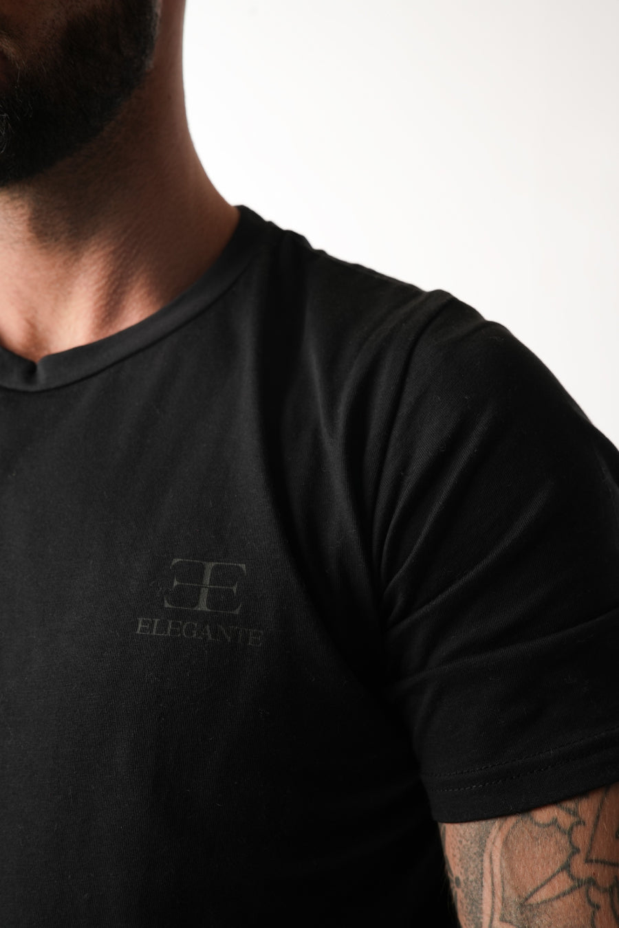 man wearing black sports tshirt on white background