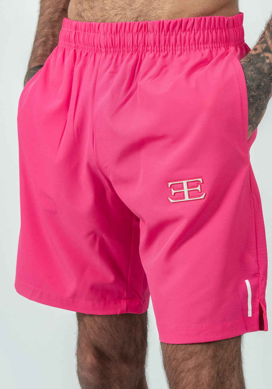 Pink shorts with a logo on a white background