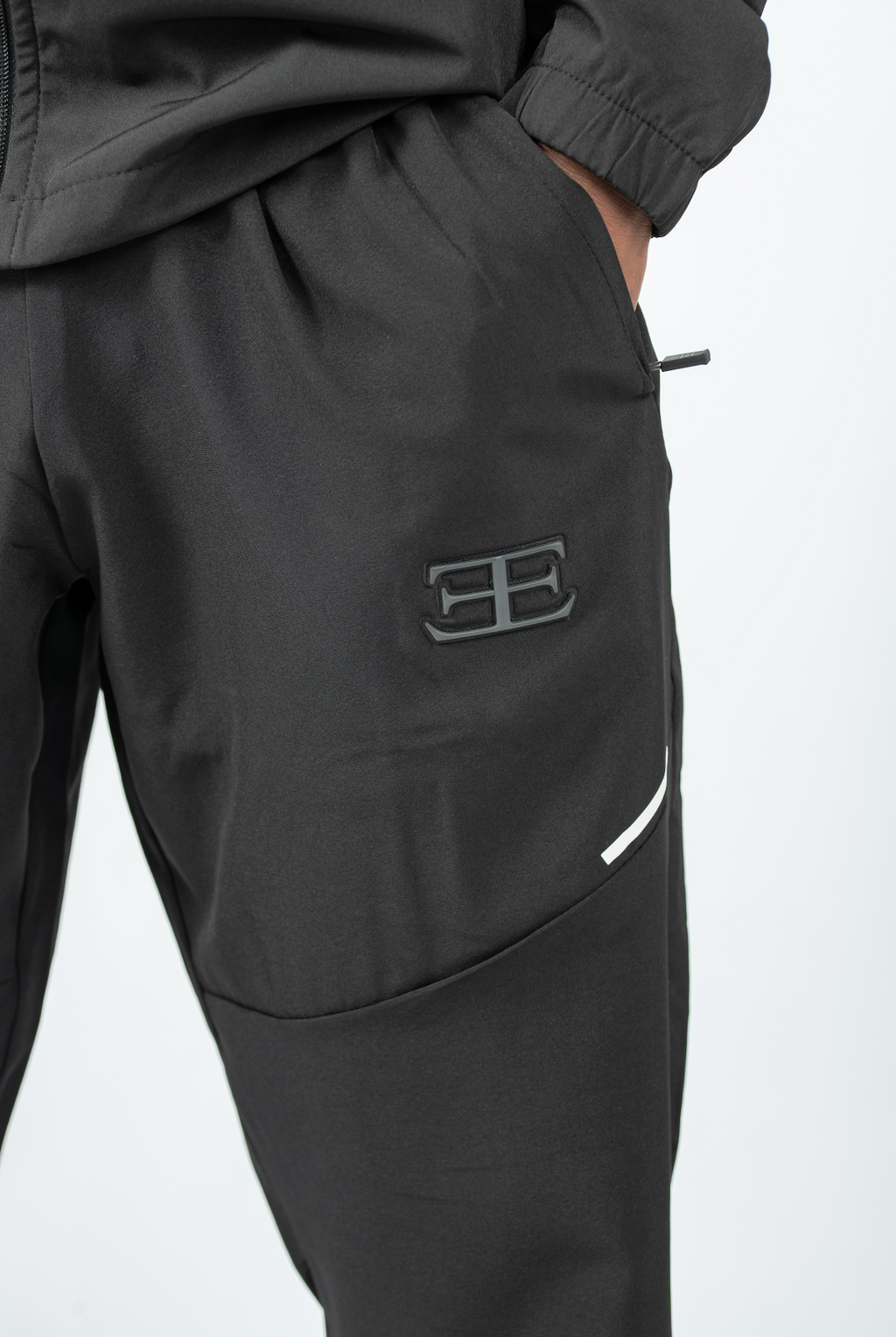 Dark gray pants with a logo on a white background