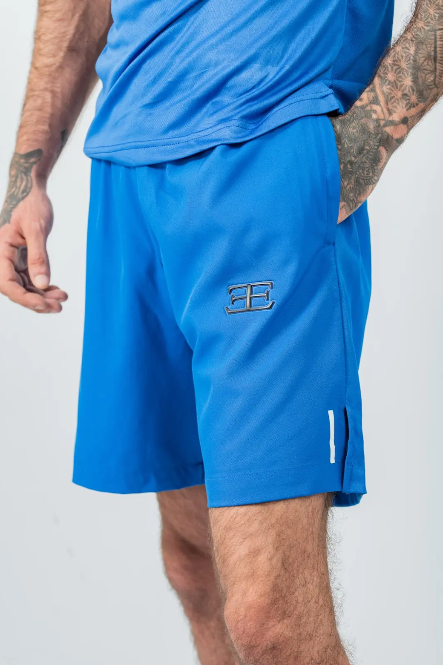 Blue athletic shorts with a logo on a white background