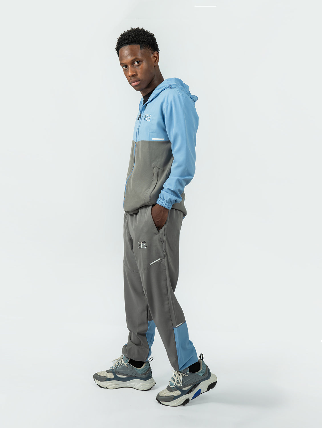 man wearing light blue and grey Tracksuit jogger, mens sports tracksuit sets, 