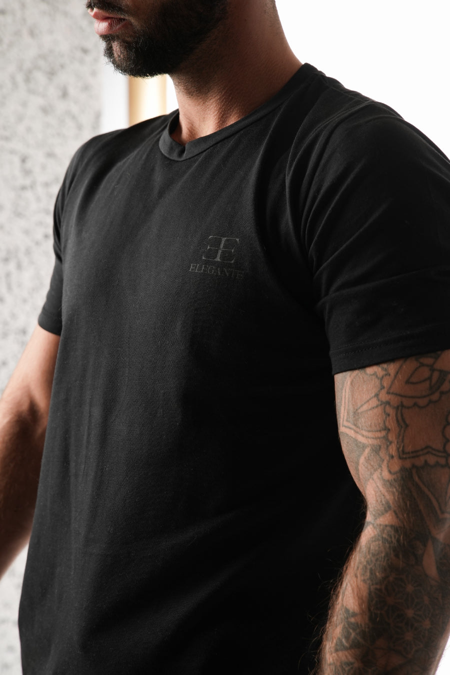 man wearing black sports tshirt on white background