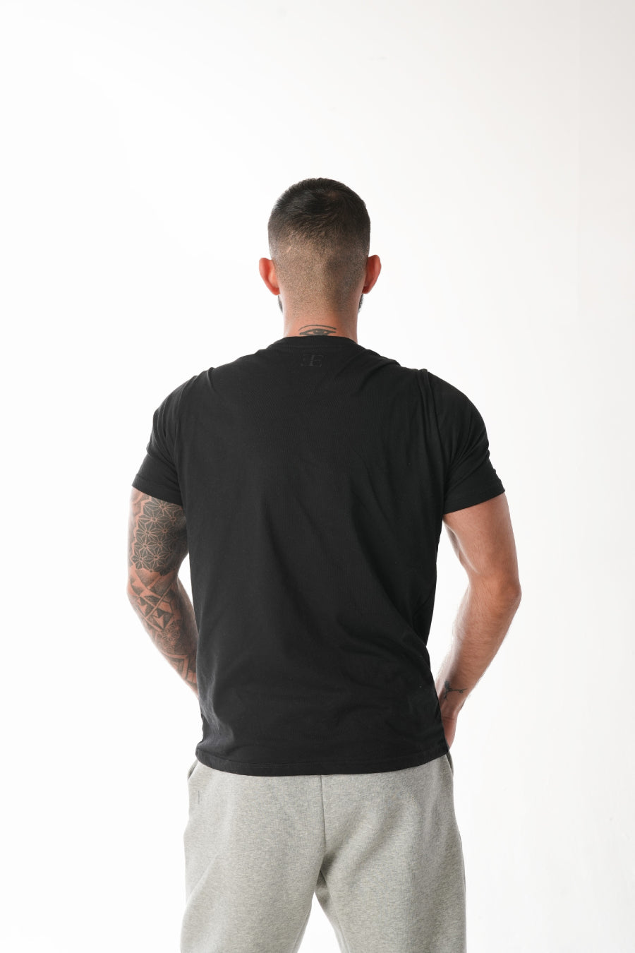 man wearing black sports tshirt on white background