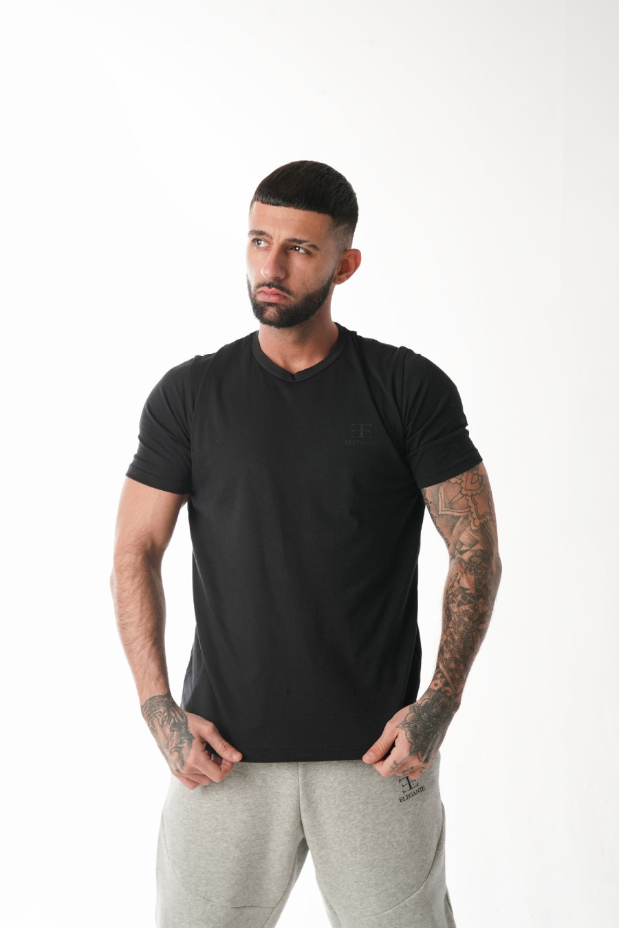 man wearing black sports tshirt on white background