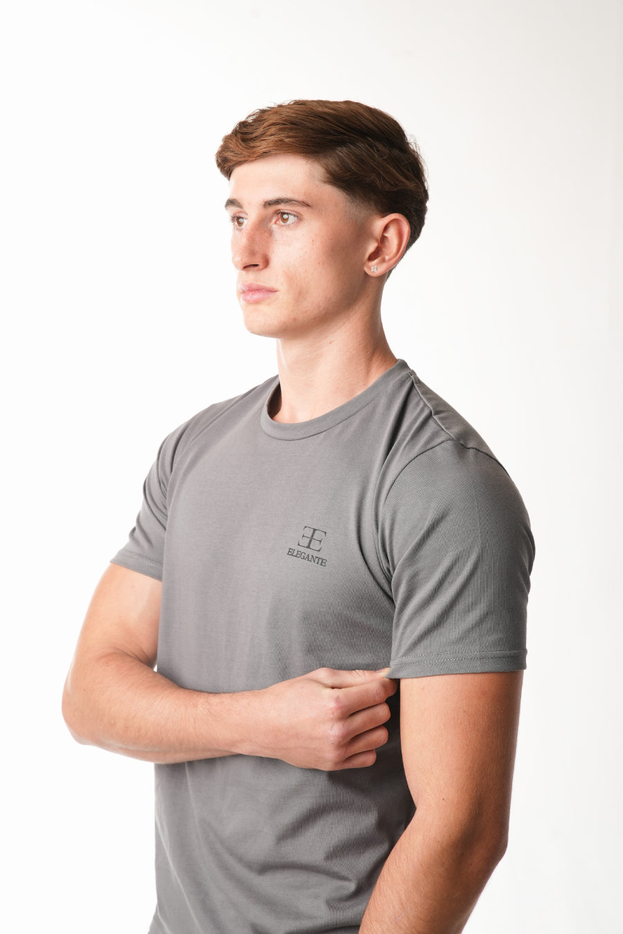 man wearing grey tshirt with elegante logo on chest on white background