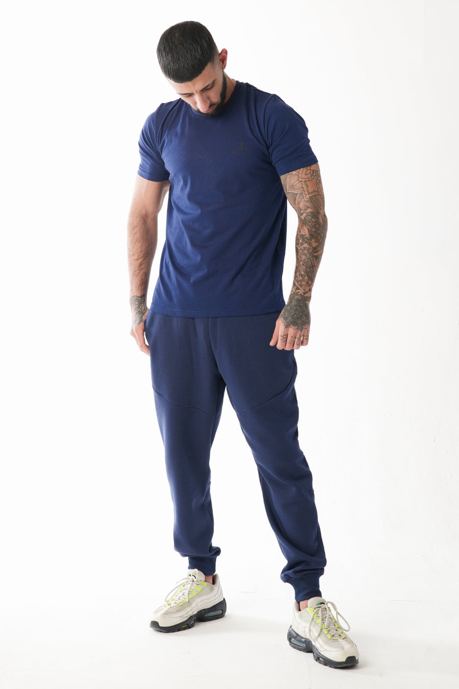 Man wearing a blue athletic outfit on a white background