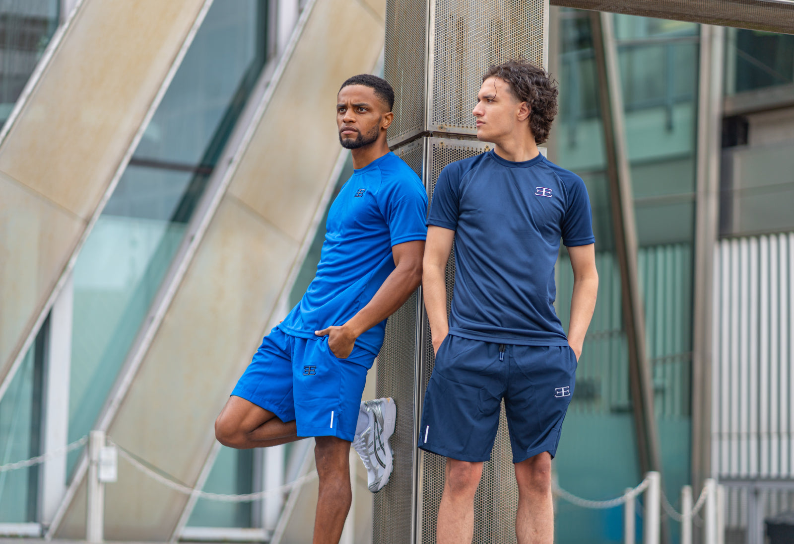 gymwear for men, sportwear, 2 men wearing tshirt and top and shorts in grey and navy blue set